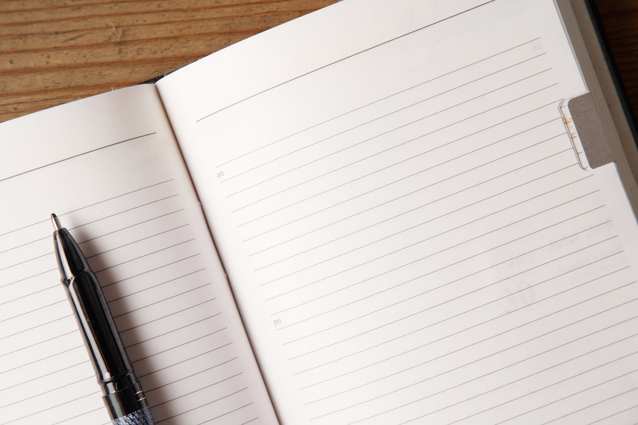 Top view, empty notebook on a wood background