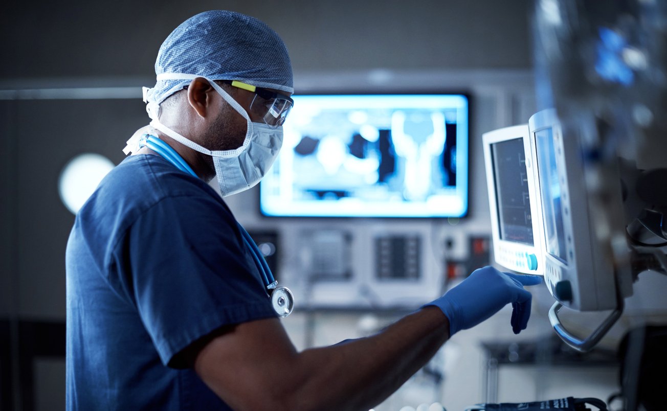 Shot of a surgeon looking at a monitor in an operating room