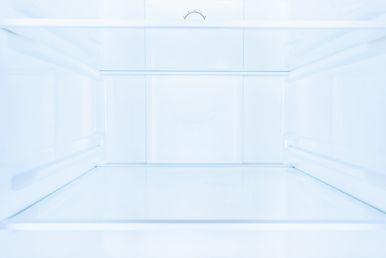 shelves in empty open white fridge