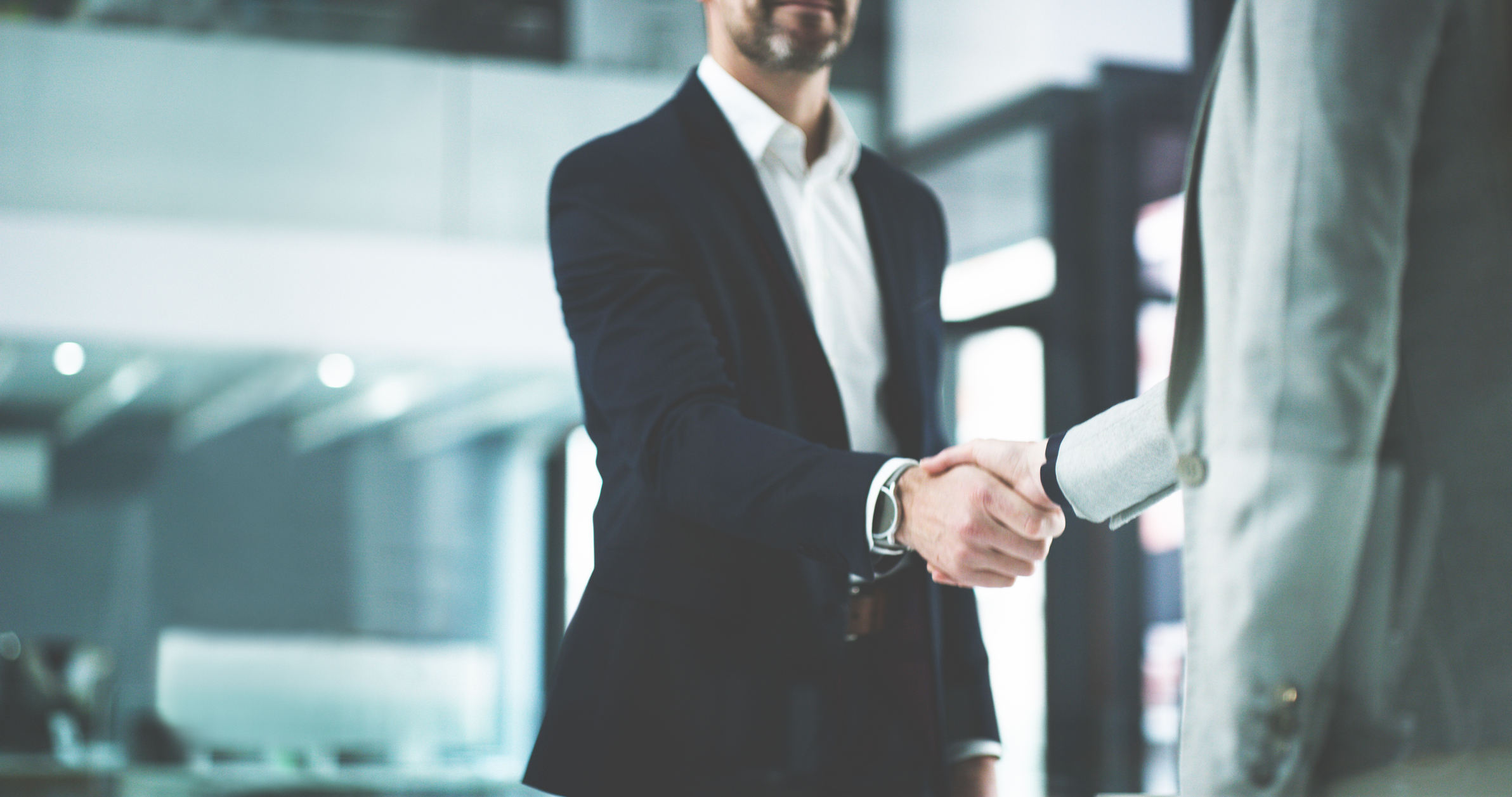 Closeup shot of two businesspeople shaking hands in an office