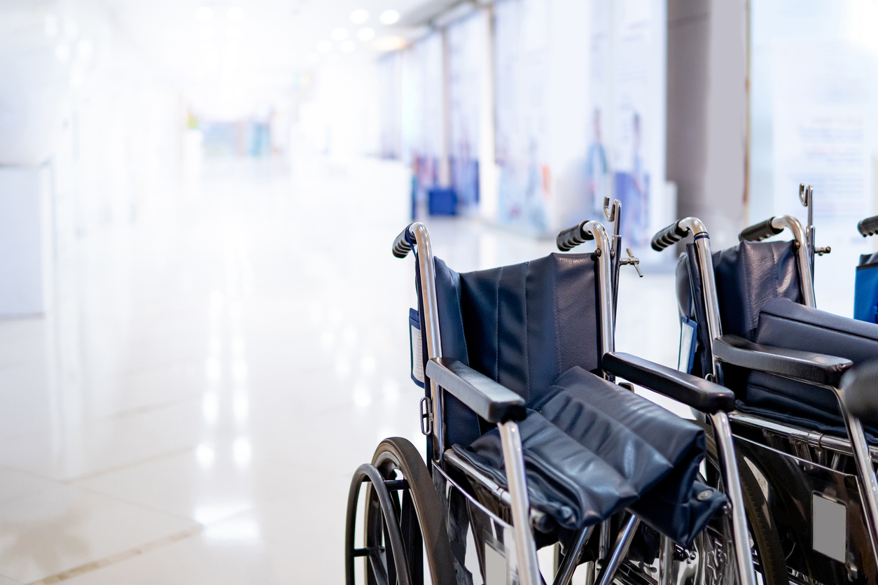 Group of blue folding wheelchair with blurred corridor in hospital or medical clinic. Healthcare and medical service concept